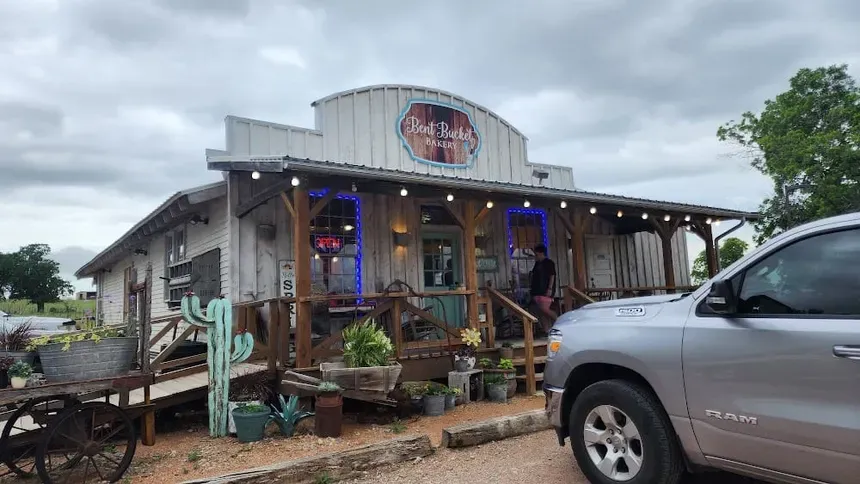 The bakery porch from the side, with steps up to a turquoise door